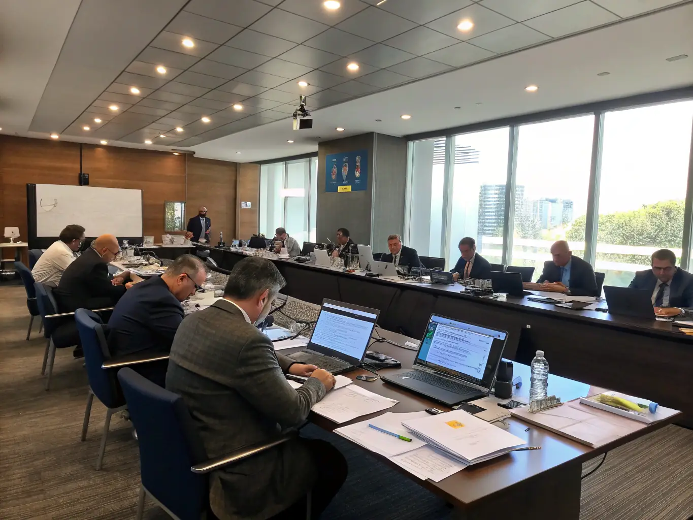 A professional photograph of government officials collaborating in a modern, secure office environment, emphasizing the importance of secure document handling and compliance.